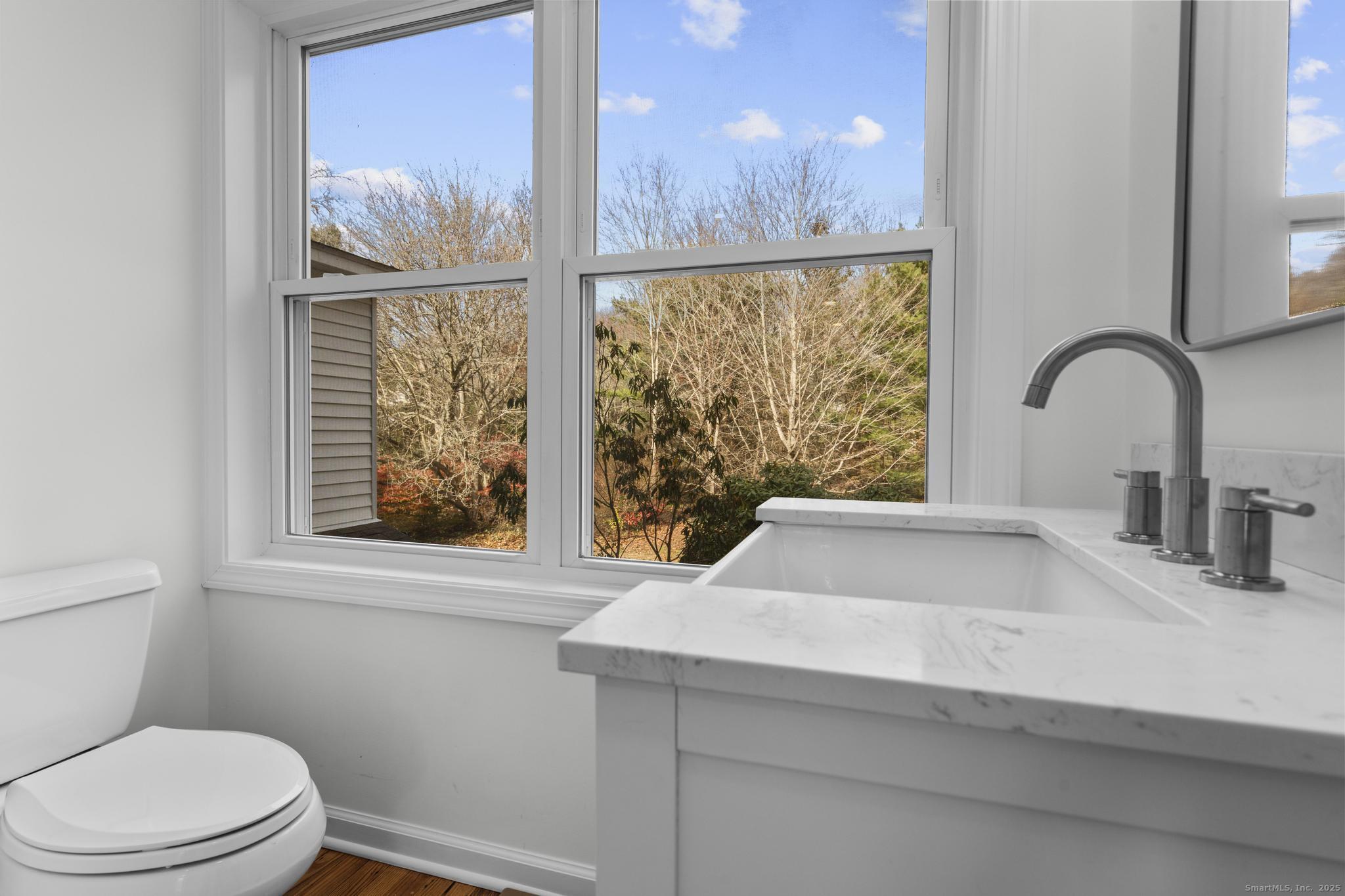 1092 Durham Road Guilford, CT 06437 - Photo 16 of 38 a bathroom with a sink a toilet and a window