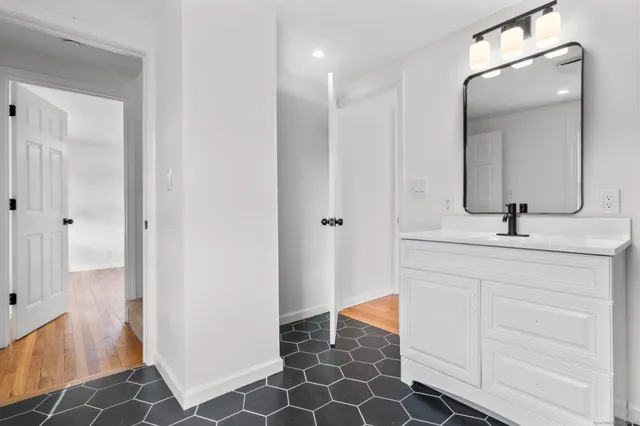 a bathroom with a shower sink and mirror