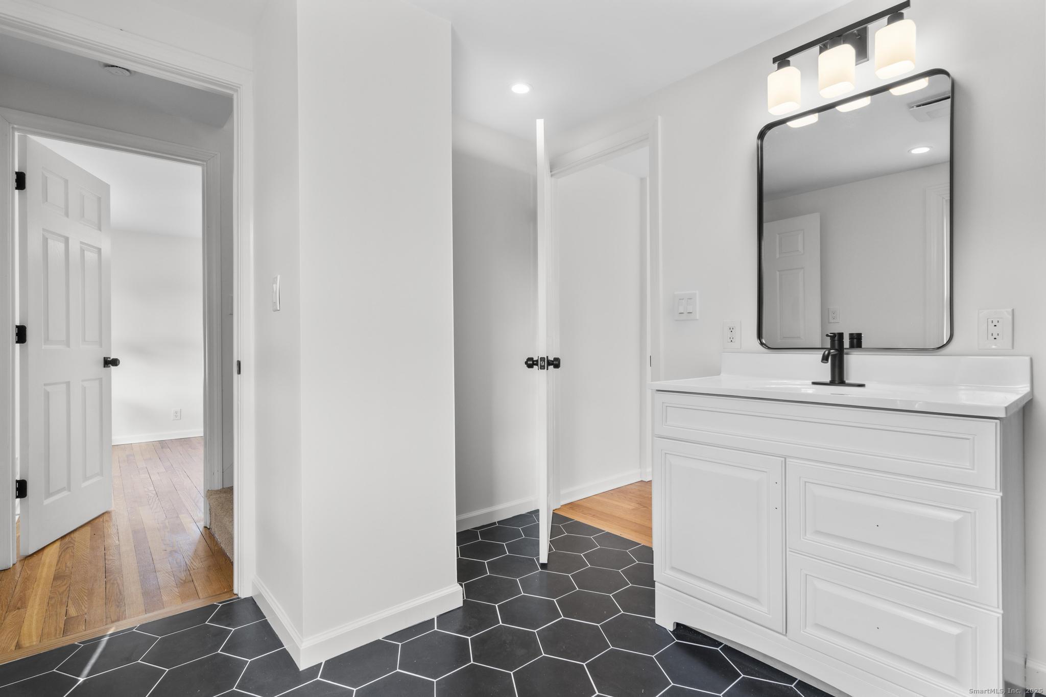 1092 Durham Road Guilford, CT 06437 - Photo 18 of 38 a bathroom with a sink and a mirror