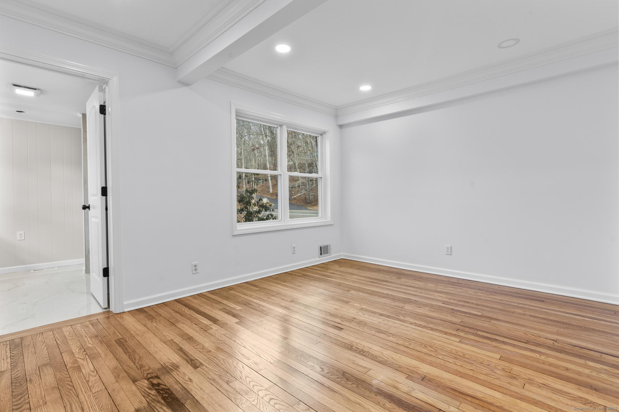 1092 Durham Road Guilford, CT 06437 - Photo 9 of 38 a view of empty room with wooden floor and fan