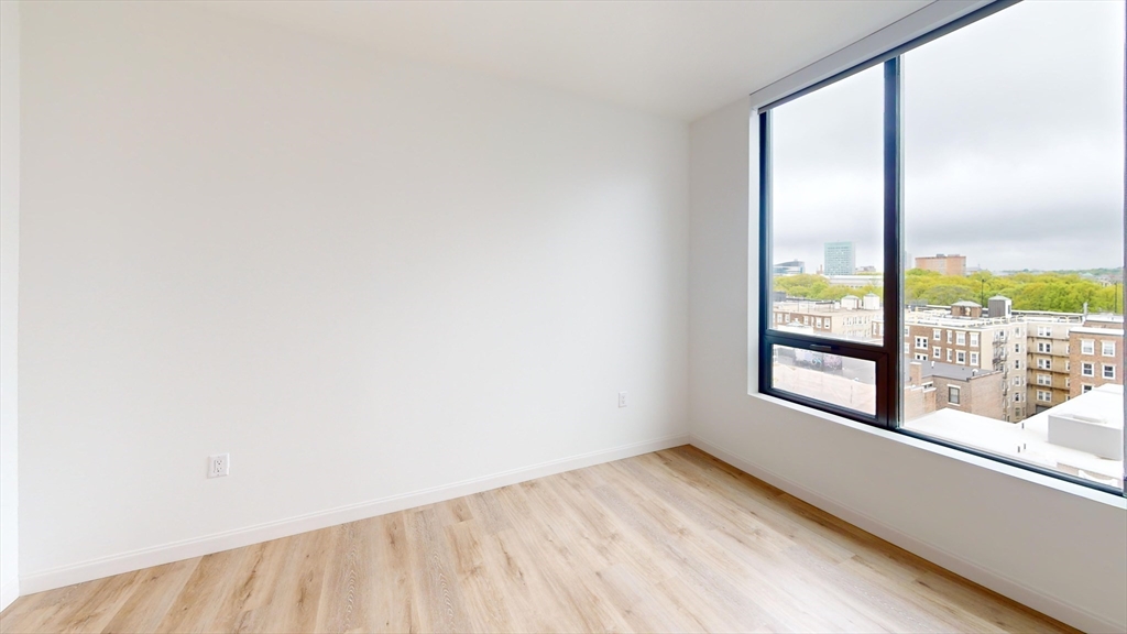 60 Kilmarnock Street, Unit 842 Boston, MA 02215 - Photo 7 of 13 an empty room with wooden floor and windows