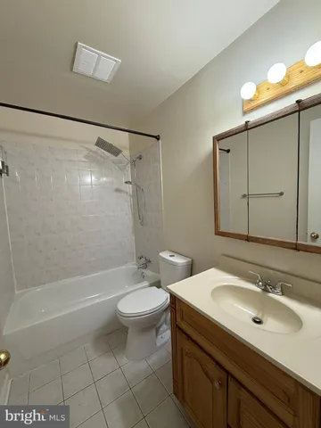 a bathroom with a sink mirror toilet and bathtub