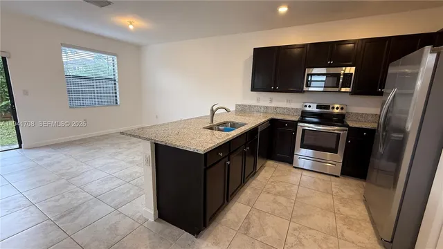 a kitchen with a sink appliances and cabinets