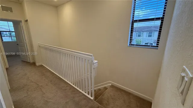 a view of a hallway with staircase