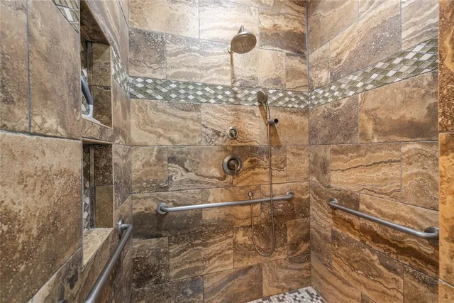 a en suite bathroom with a granite countertop sink and a mirror