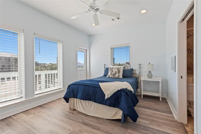 a bedroom with bed and wooden floor