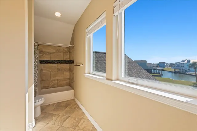 an aerial view of a house with a lake view