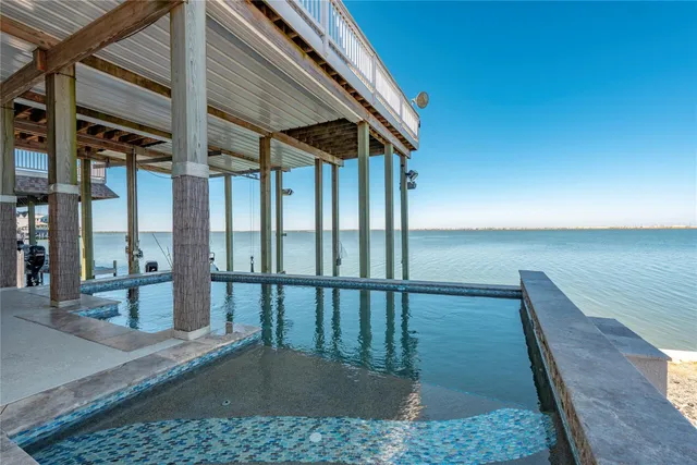a roof deck with table and chairs and wooden floor