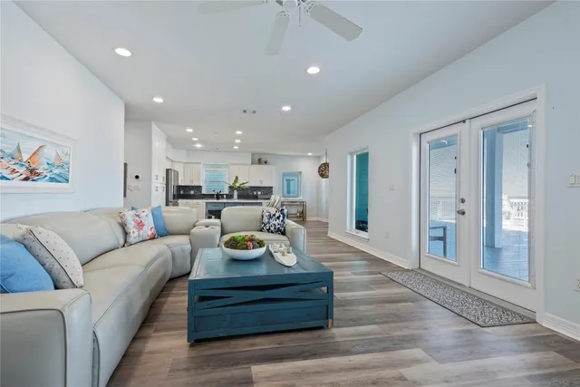 a kitchen with stainless steel appliances a stove a sink a refrigerator and a microwave