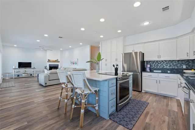 a bedroom with a bed a couch and large window
