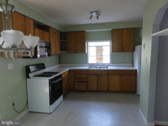 234 Baldwin Road Front Royal, VA 22630 - Photo 5 of 14 a kitchen with stainless steel appliances granite countertop a stove a sink and a refrigerator
