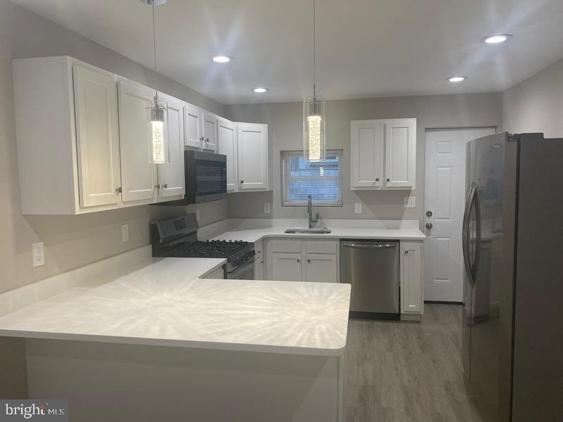 224 North Rose Street Baltimore, MD 21224 - Photo 1 of 14 a kitchen with stainless steel appliances granite countertop a sink refrigerator and cabinets
