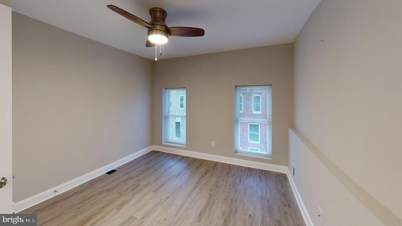 224 North Rose Street Baltimore, MD 21224 - Photo 4 of 14 a view of livingroom with hardwood floor and window