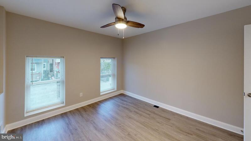 224 North Rose Street Baltimore, MD 21224 - Photo 5 of 14 wooden floor in an empty room with a window
