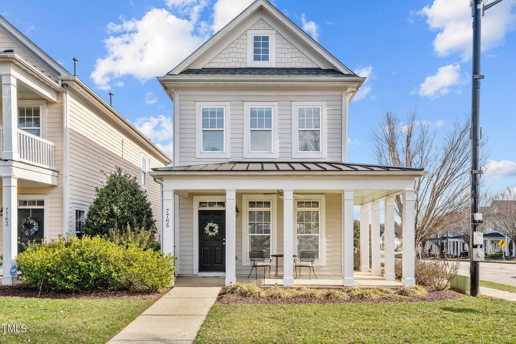 7765 Courtney Estates Drive Raleigh, NC 27617 - Photo 1 of 37 a front view of a house with garden