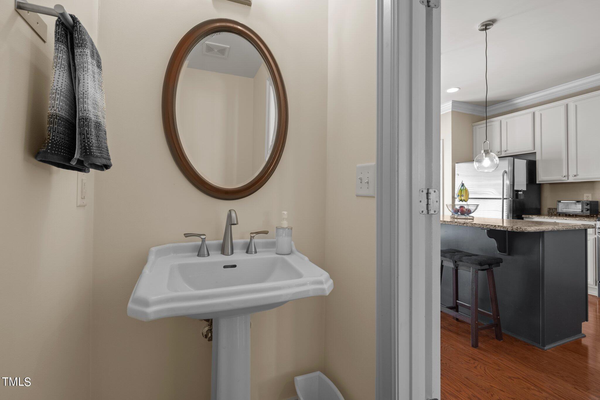 7765 Courtney Estates Drive Raleigh, NC 27617 - Photo 17 of 37 a bathroom with a sink and a mirror