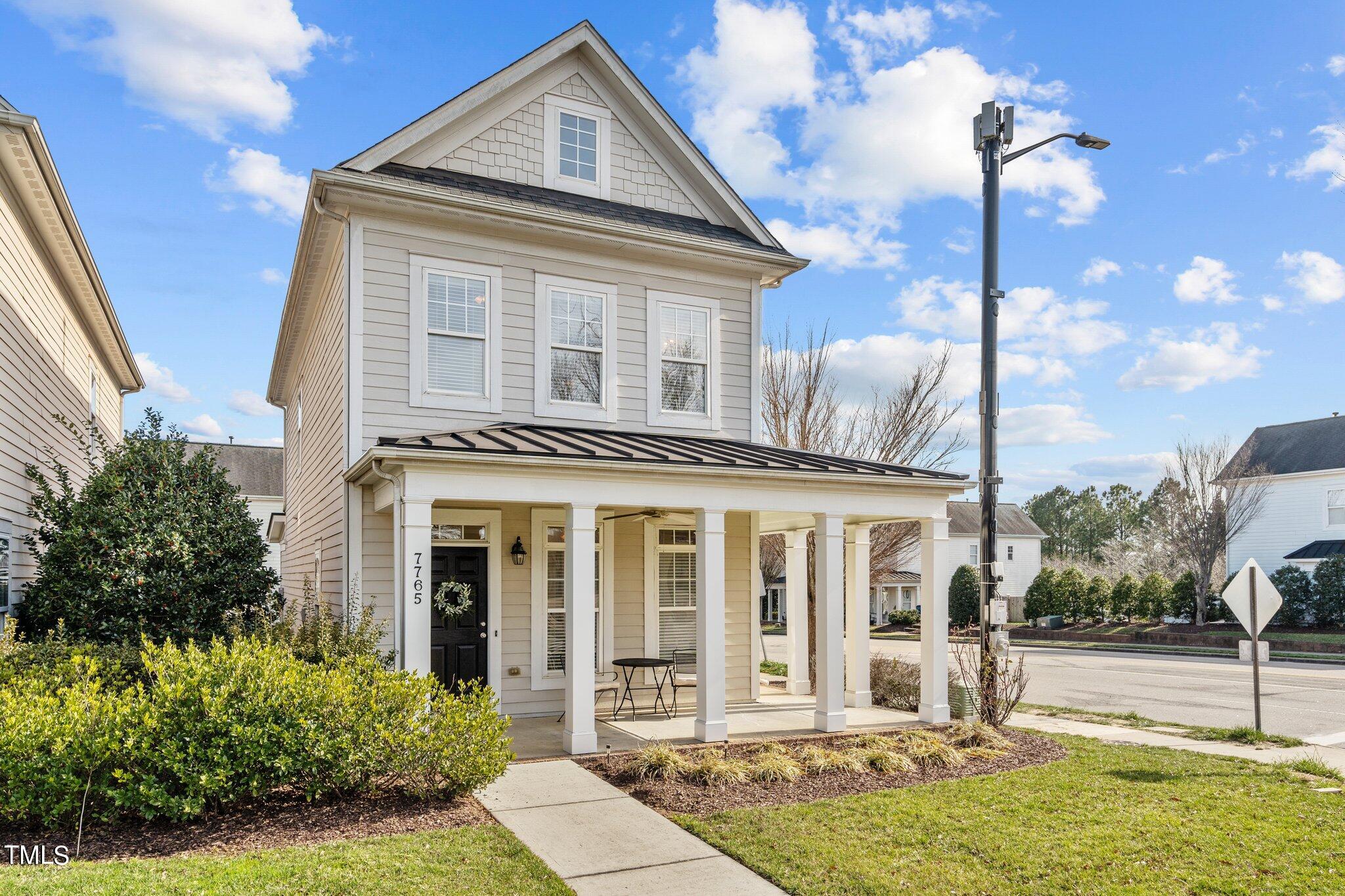 7765 Courtney Estates Drive Raleigh, NC 27617 - Photo 2 of 37 a front view of a house with a yard