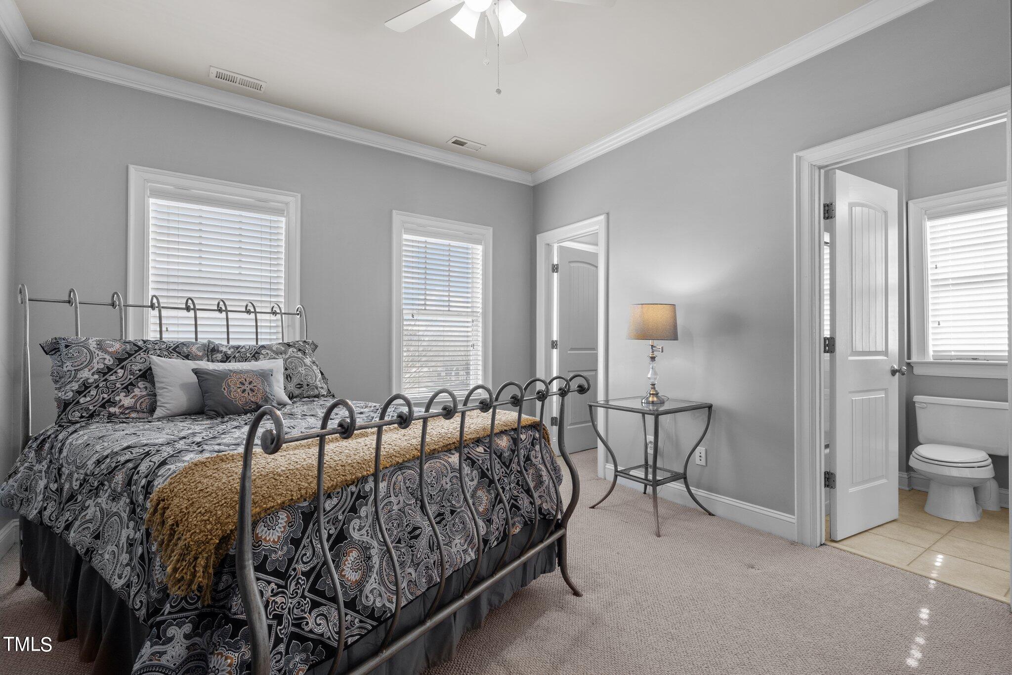 7765 Courtney Estates Drive Raleigh, NC 27617 - Photo 22 of 37 a bedroom with double bed and a chandelier