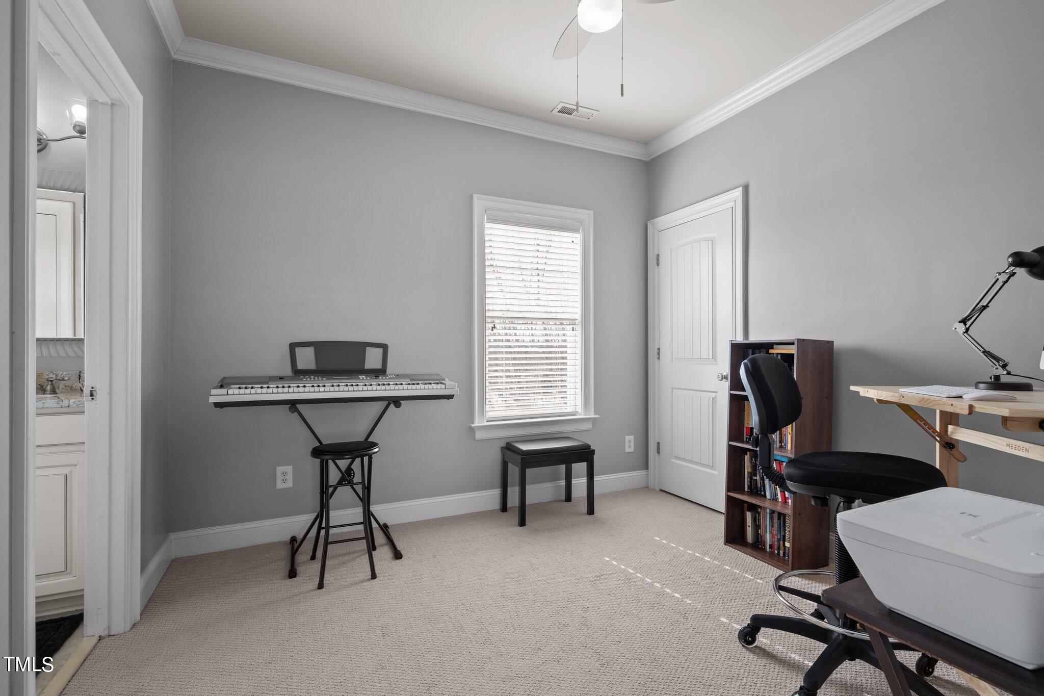 7765 Courtney Estates Drive Raleigh, NC 27617 - Photo 24 of 37 a view of a workspace with furniture and a window