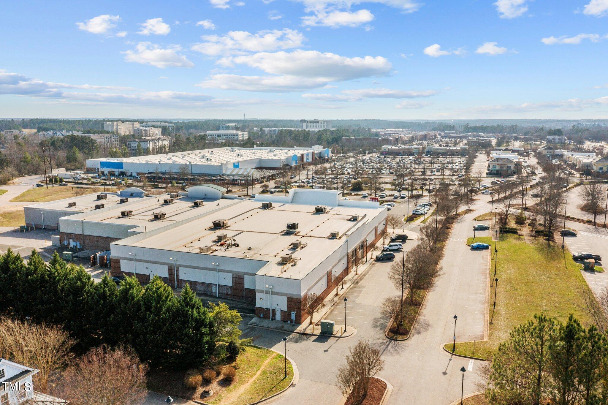 7765 Courtney Estates Drive Raleigh, NC 27617 - Photo 35 of 37 an aerial view of a building with an outdoor space and seating