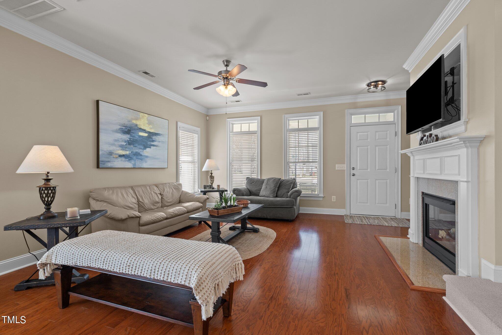 7765 Courtney Estates Drive Raleigh, NC 27617 - Photo 5 of 37 a living room with furniture fireplace and flat screen tv