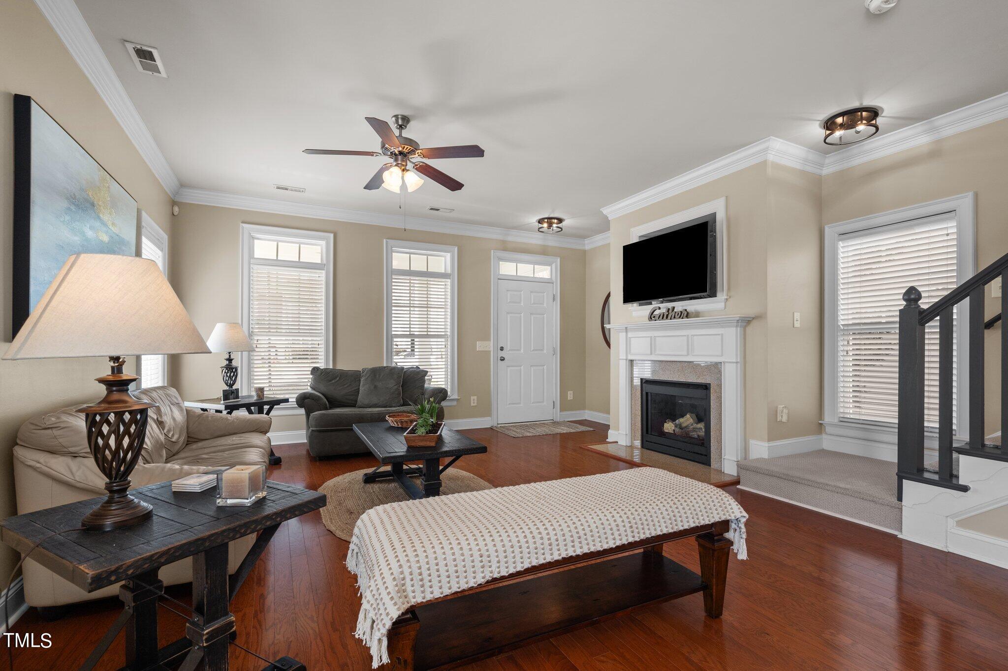 7765 Courtney Estates Drive Raleigh, NC 27617 - Photo 6 of 37 a living room with furniture fireplace and flat screen tv