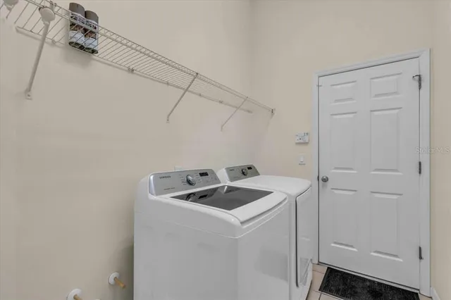 an empty room with a ceiling fan and window