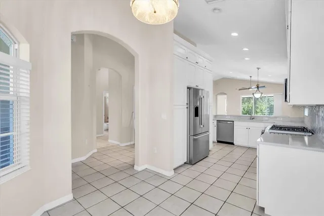 a kitchen with white cabinets and white appliances