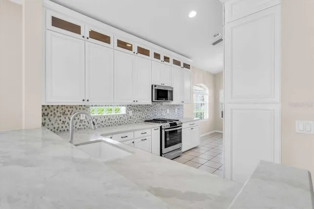 a view of a kitchen with a sink and window