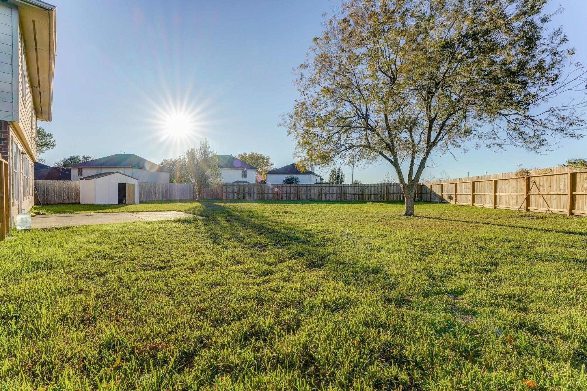 5123 Alderney Court Rosenberg, TX 77471 - Photo 6 of 9 a view of yard with swimming pool and green space