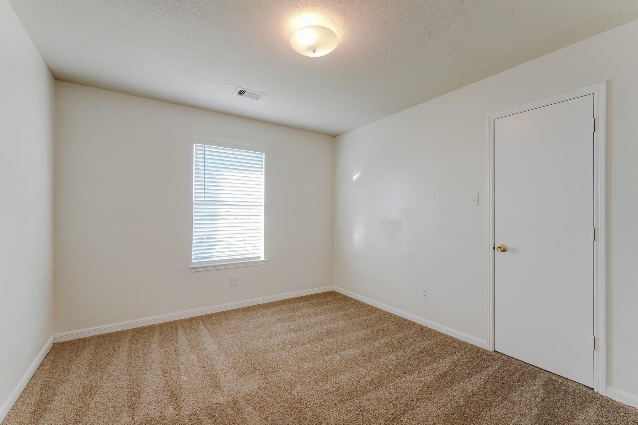 5123 Alderney Court Rosenberg, TX 77471 - Photo 7 of 9 a view of an empty room with a window