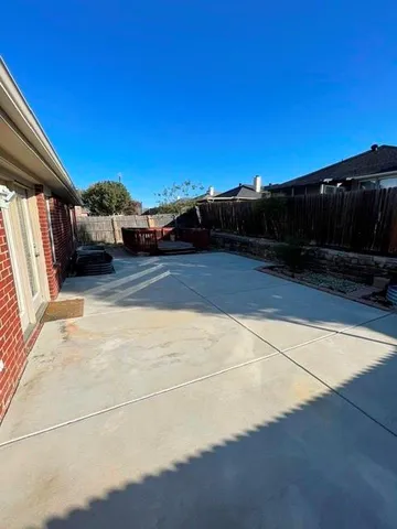 a view of a swimming pool with an outdoor seating and a yard