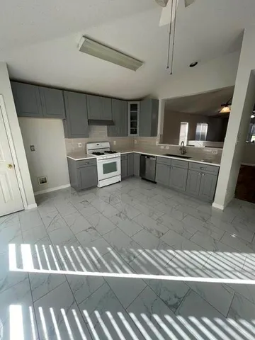 a kitchen with stainless steel appliances kitchen island granite countertop a sink and cabinets