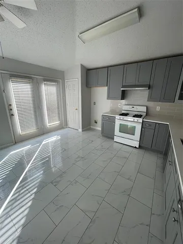 a kitchen with a stove a sink and a refrigerator