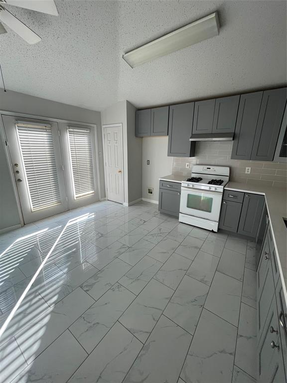6800 Geyser Trail Watauga, TX 76137 - Photo 6 of 20 a kitchen with a stove a sink and a refrigerator