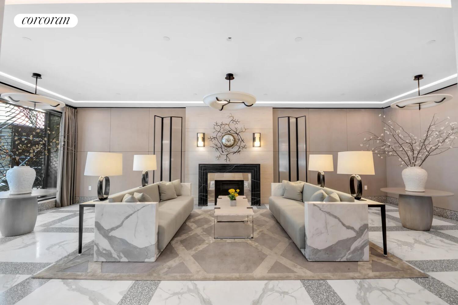 40 Bleecker Street, Unit 4A Manhattan, NY 10012 - Photo 11 of 16 a living room with furniture a fireplace and a chandelier