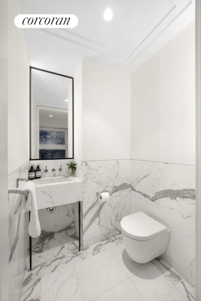 40 Bleecker Street, Unit 4A Manhattan, NY 10012 - Photo 10 of 16 a bathroom with a toilet a sink and mirror