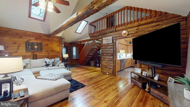 a kitchen with a table chairs refrigerator and cabinets
