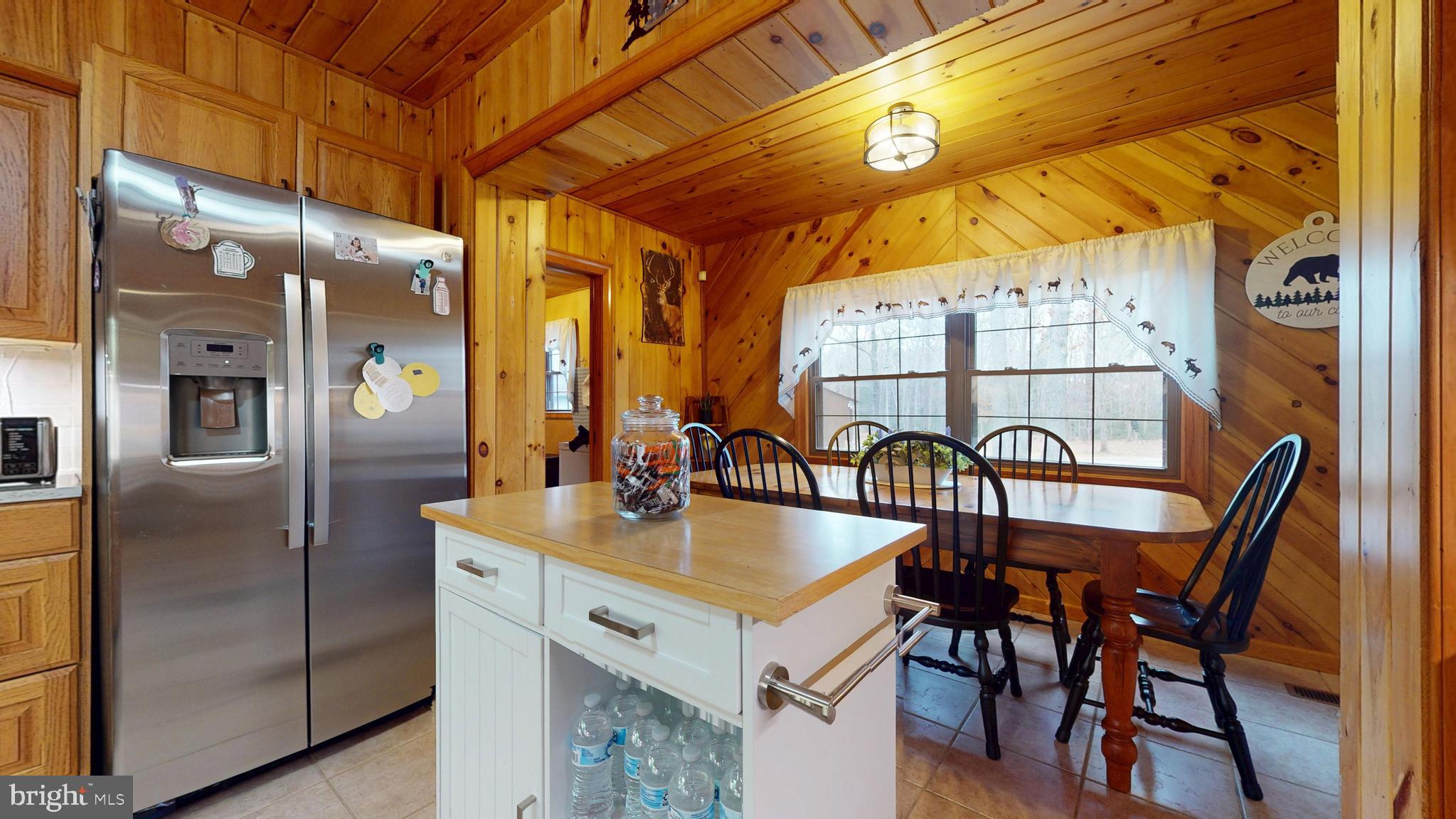 853 Clarks Landing Road Egg Harbor City, NJ 08215 - Photo 45 of 62 a kitchen with a table chairs refrigerator and cabinets