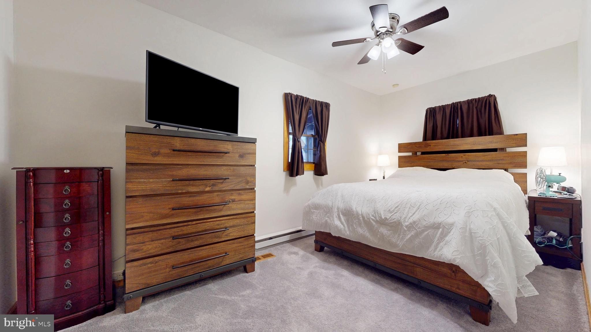 853 Clarks Landing Road Egg Harbor City, NJ 08215 - Photo 52 of 62 a bedroom with a bed and a flat screen tv