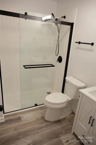 a bathroom with a toilet and a shower