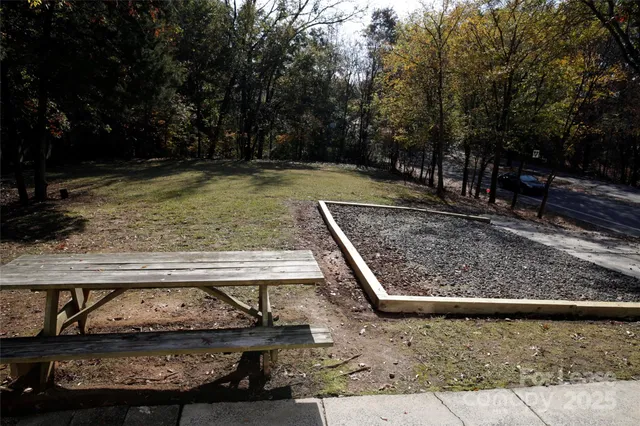 a view of a yard with wooden fence