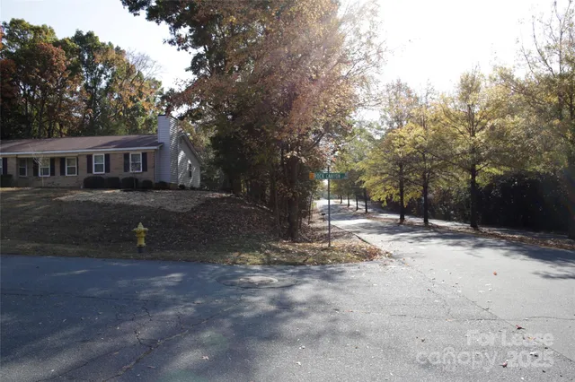 a backyard of a house with barbeque oven and trees