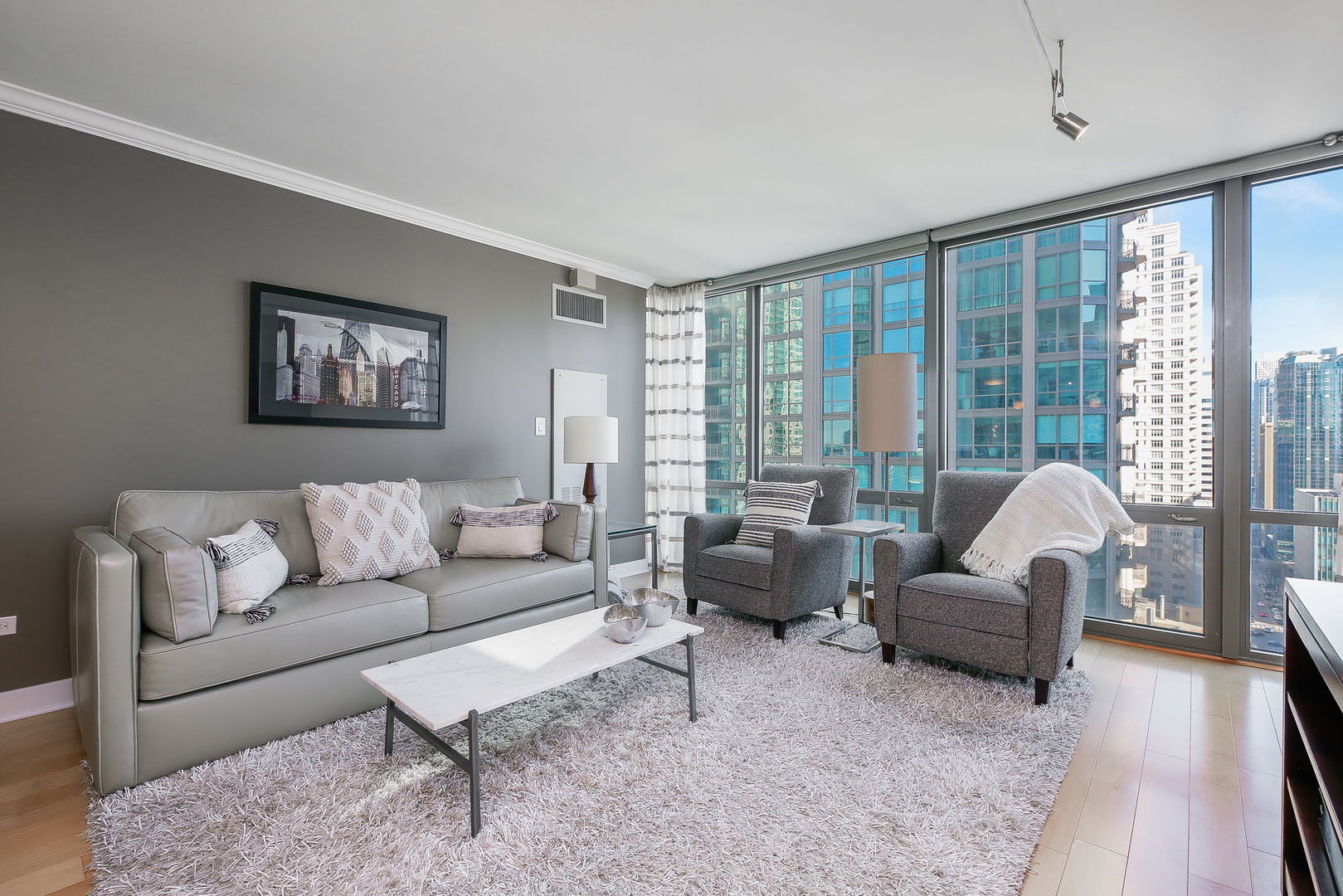 2 East Erie Street, Unit 2101 Chicago, IL 60611 - Photo 3 of 13 a living room with furniture and a large window