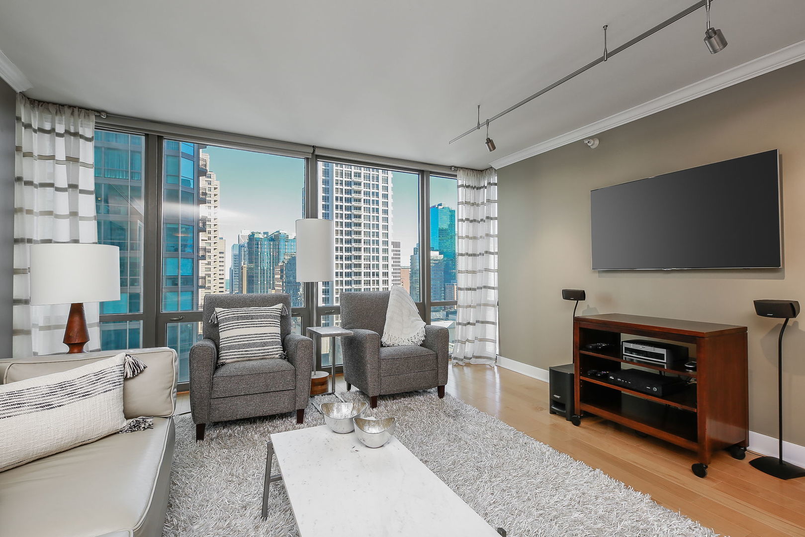 2 East Erie Street, Unit 2101 Chicago, IL 60611 - Photo 4 of 13 a living room with furniture and a flat screen tv