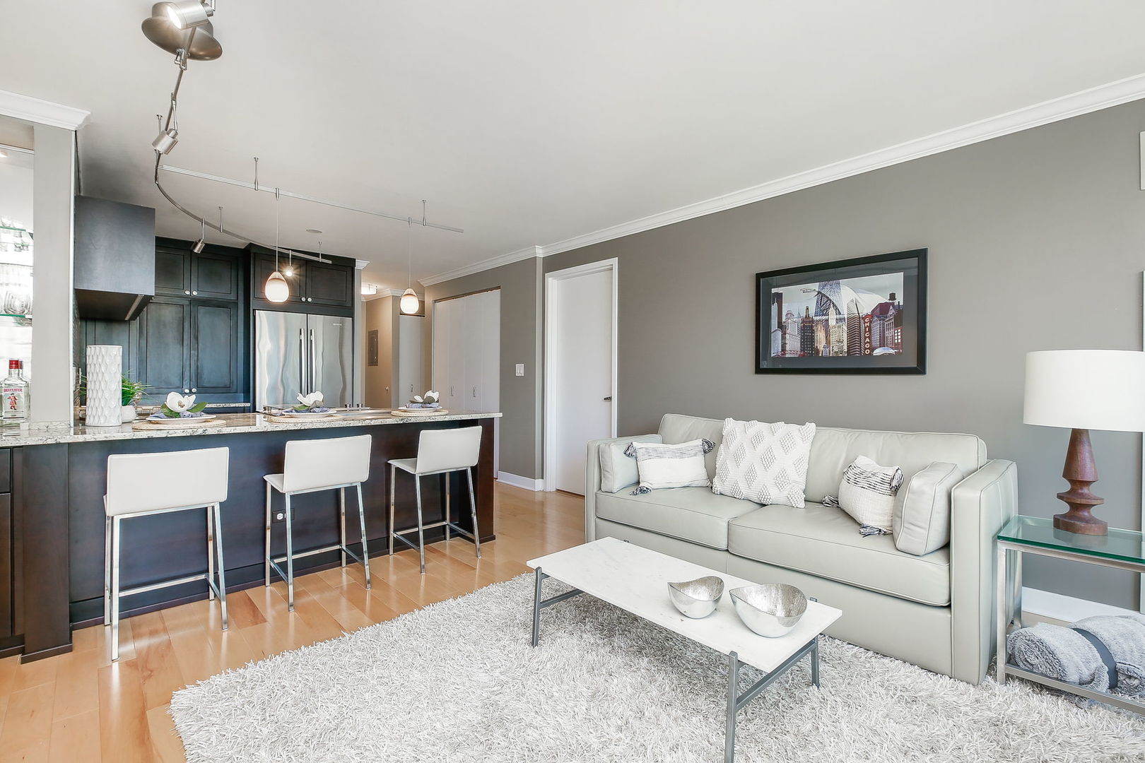 2 East Erie Street, Unit 2101 Chicago, IL 60611 - Photo 5 of 13 a living room with furniture a dining table and a potted plant