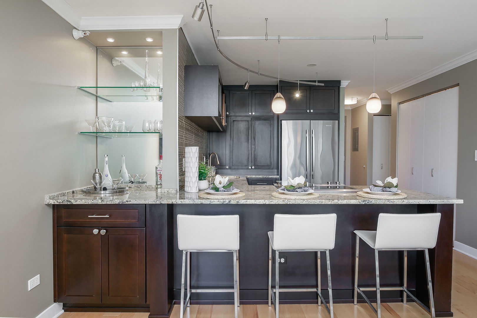 2 East Erie Street, Unit 2101 Chicago, IL 60611 - Photo 6 of 13 a kitchen with granite countertop a sink and cabinets