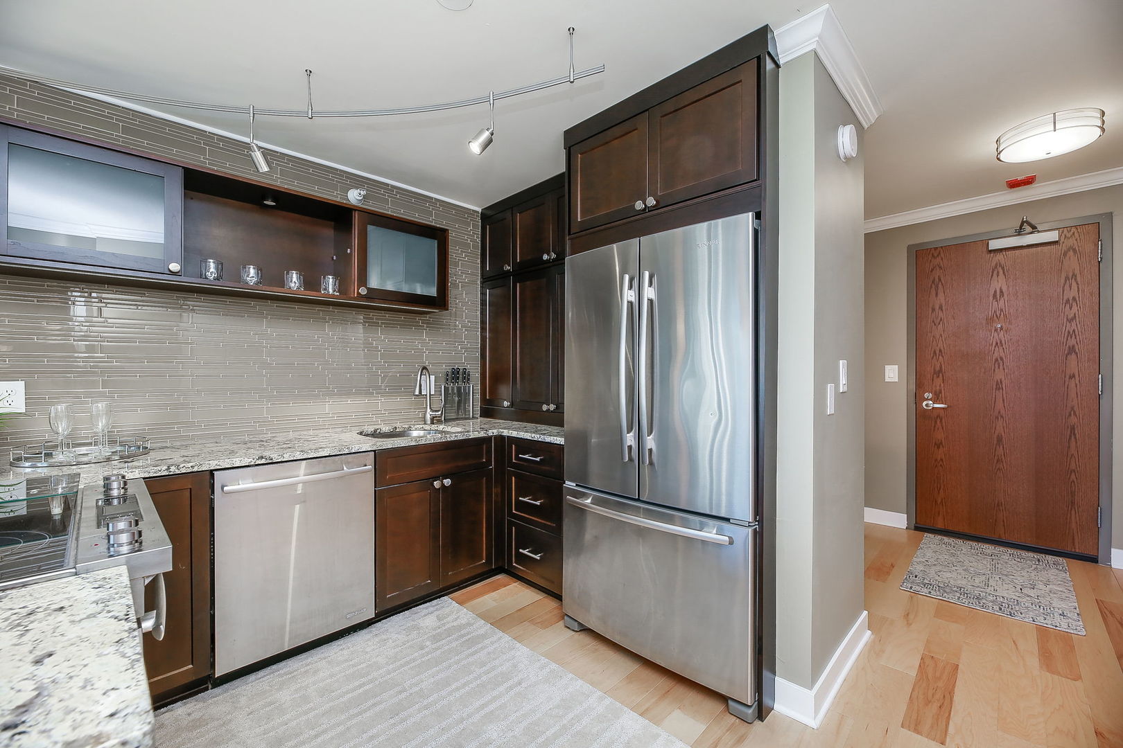 2 East Erie Street, Unit 2101 Chicago, IL 60611 - Photo 7 of 13 a kitchen with stainless steel appliances granite countertop a refrigerator and a sink