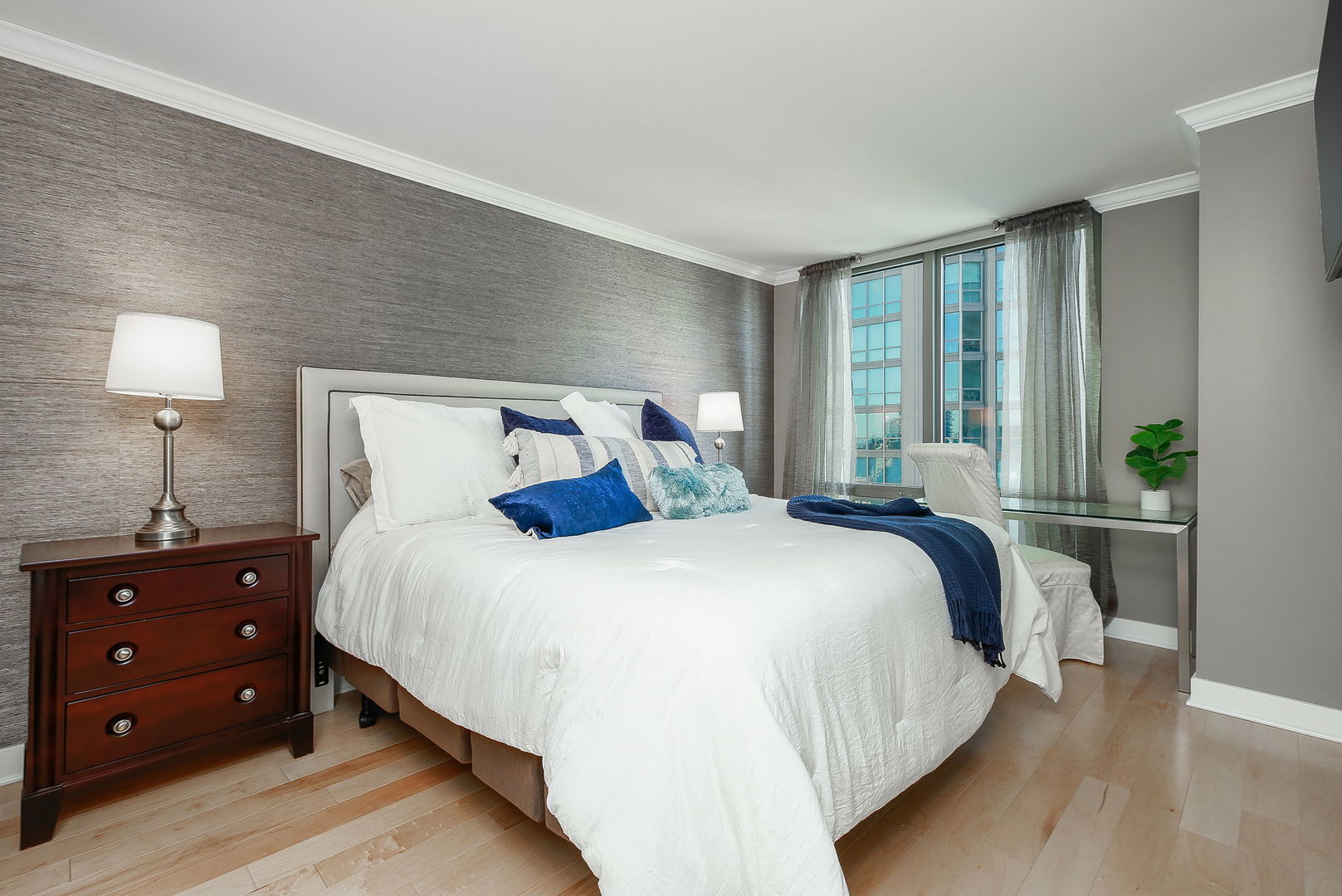 2 East Erie Street, Unit 2101 Chicago, IL 60611 - Photo 9 of 13 a bedroom with a bed and a lamp