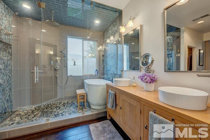 10520 Baton Court Reno, NV 89521 - Photo 11 of 38 a spacious bathroom with a granite countertop sink a toilet a mirror and shower